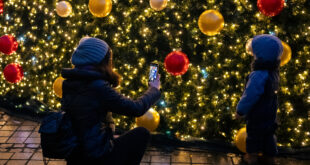 “Cozy living room decorated with warm Christmas lights, festive home décor, and a glowing holiday ambiance.”